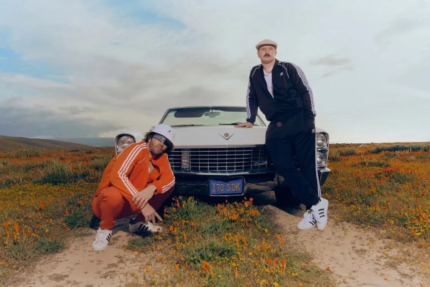 Lee Foss & Ralf pose by a Cadillac